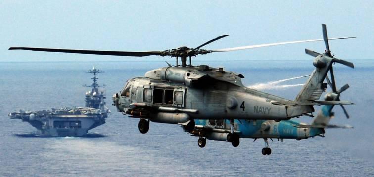 Navy helicopter and the USS Abraham Lincoln
